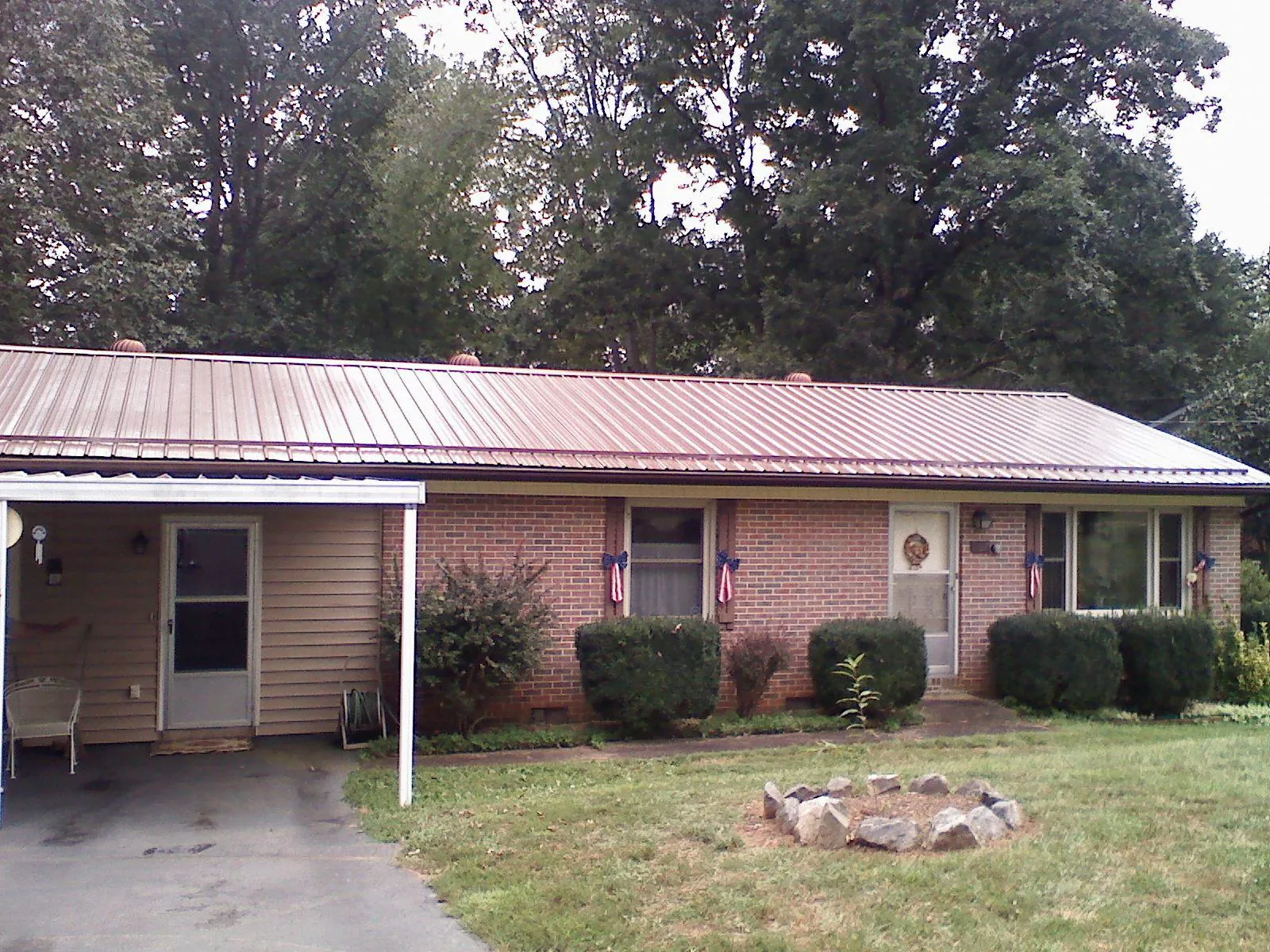 Bronze metal roof and carport on a brick ranch home — Roof Repair work by our crew in East Pittsburgh